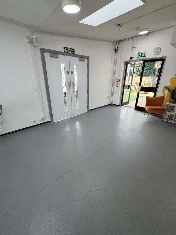Bright school entrance hall with a clean grey floor